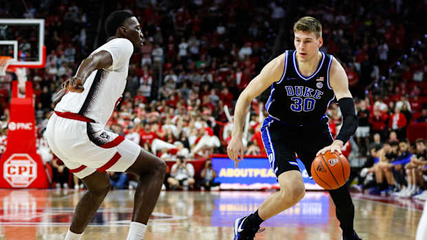 Mar 4, 2024; Raleigh, North Carolina, USA; Duke Blue Devils center Kyle Filipowski (30) dribbles with the ball guarded by North Carolina State Wolfpack guard Jordan Snell (22) during the first half against at PNC Arena. Mandatory Credit: Jaylynn Nash-USA TODAY Sports